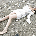Aki Hoshino laying on beach looking sexy in bikini - image 