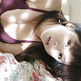 Aki Hoshino laying on beach looking sexy in bikini - image 
