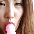 Akane sucking on a pink dildo - image 